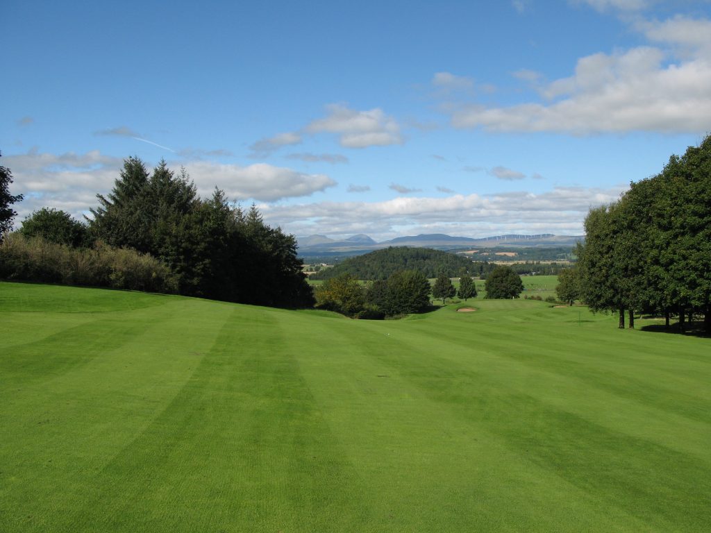 The Apex of the dog leg on the 9th, with fine hill views